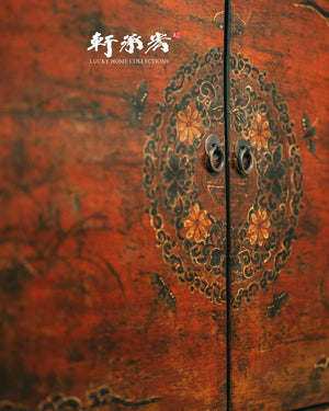 sideboard with worn painting of floral motifs