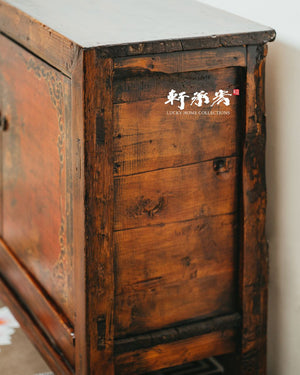 sideboard with worn painting of floral motifs