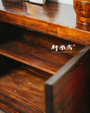 sideboard with worn painting of floral motifs