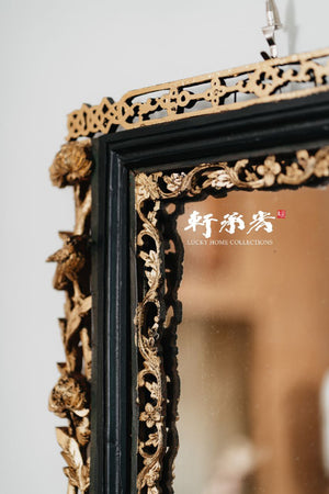 intricately carved framed mirror