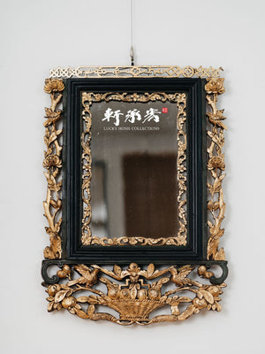 intricately carved framed mirror