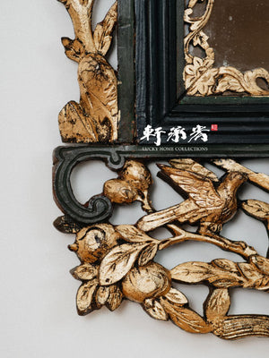 intricately carved framed mirror